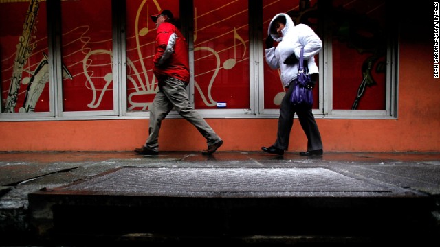 People walk in the French Quarter in New Orleans as temperatures drop on January 28.