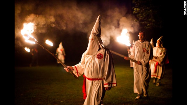 Members of the Knights of the Southern Cross of the Ku Klux Klan, joined by members of other Virginia Klan orders, participate in a cross lighting ceremony on May 28, 2011, near Powhatan, Virginia.