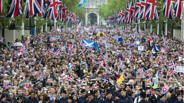 Crowds cheer and wave Union Jacks as they march down the Mall toward Buckingham Palace to celebrate the Queen's Diamond Jubilee in London on June 5, 2012. 