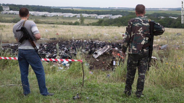 Pro-Russia rebels stand guard at the crash site.