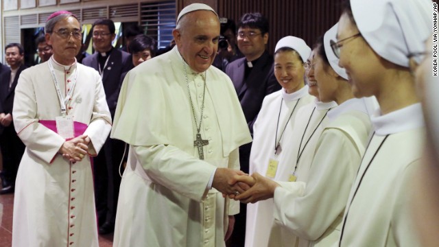 The Pope shakes hands with a nun in Seoul on August 14.