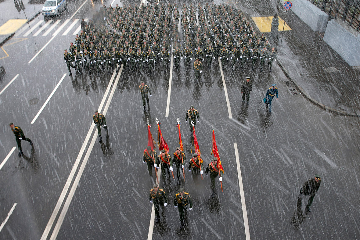 Russian servicemen walk in the snow as they rehearse for Friday's Victory Day military parade in Moscow, celebrating victory over Nazi Germany.