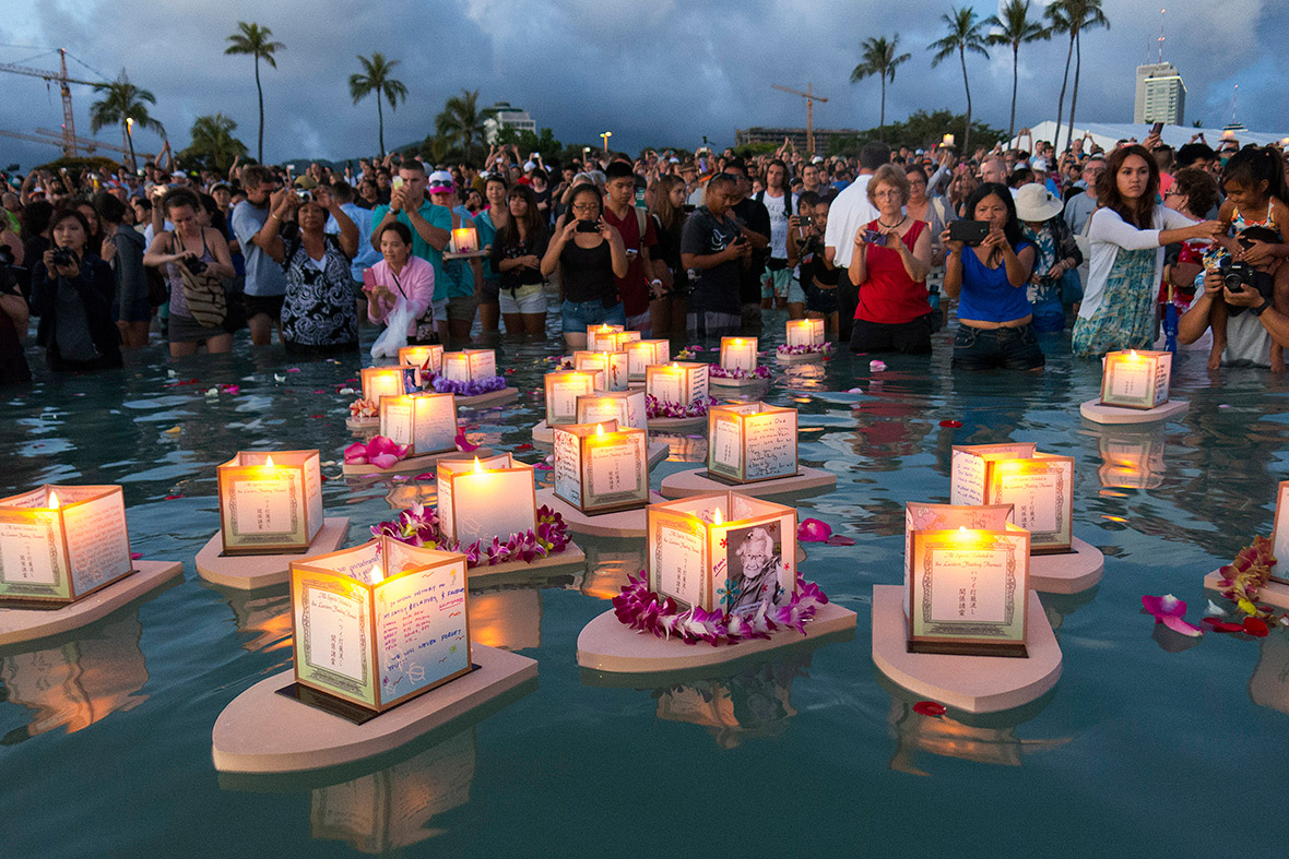 People release floating lanterns dedicated to deceased loved ones on Memorial Day, at Ala Moana Beach Park in Honolulu, Hawaii