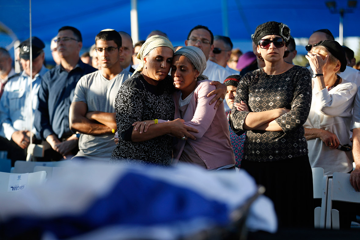 Bat-Galim Shaer (R, front) and Iris Yifrach (2nd R, front), comfort each other during the joint funeral of their sons in the Israeli city of Modi'in on 1 July