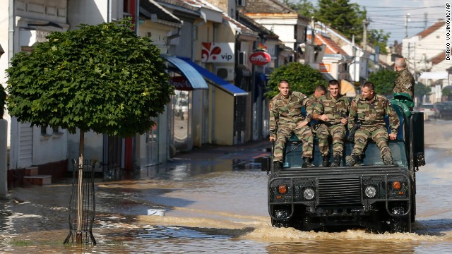 A police vehicle drives through a flooded street in Obrenovac, Serbia, on May 18.