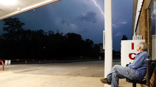 Jimmy Sullinger watches lightning as a storm approaches the gas station where he works in Berry, Alabama, on April 28. Alabama Gov. Robert Bentley declared a state of emergency for all counties.