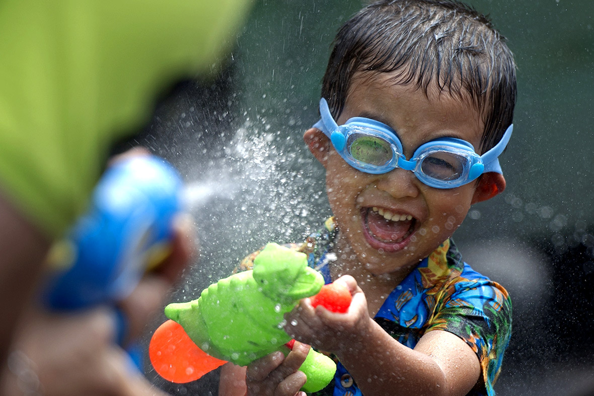 A Thai child takes part in a water battle to celebrate Thai New Year on Khaosan road in Bangkok