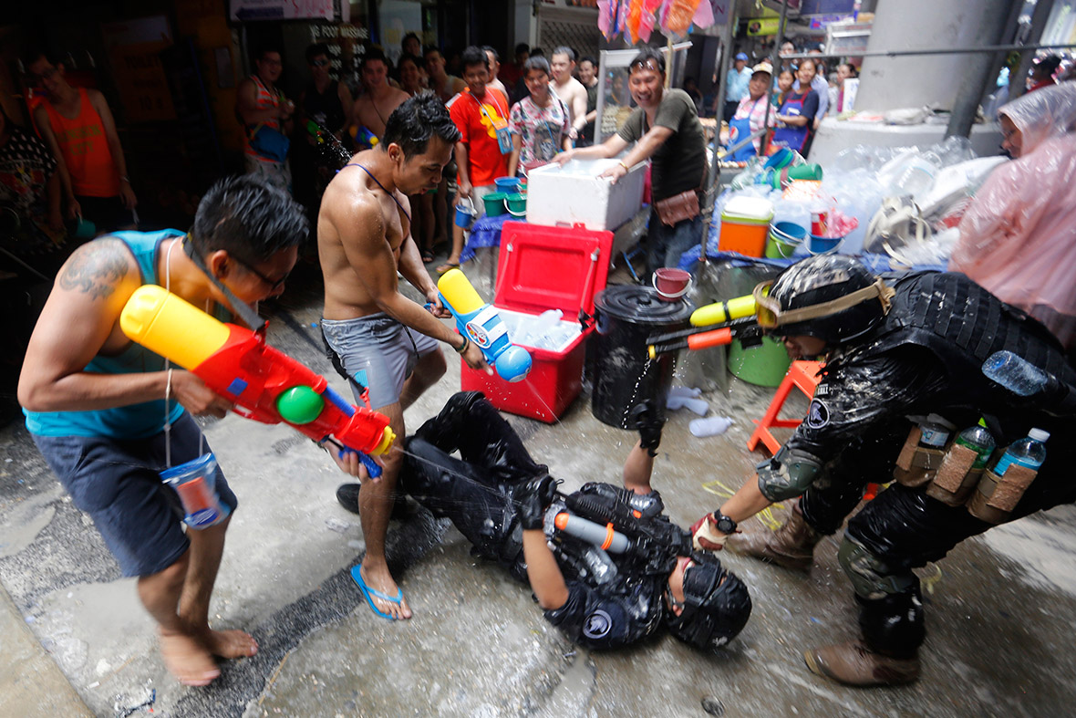 Revellers take part in a water fight during Songkran celebrations on Silom Road in Bangkok