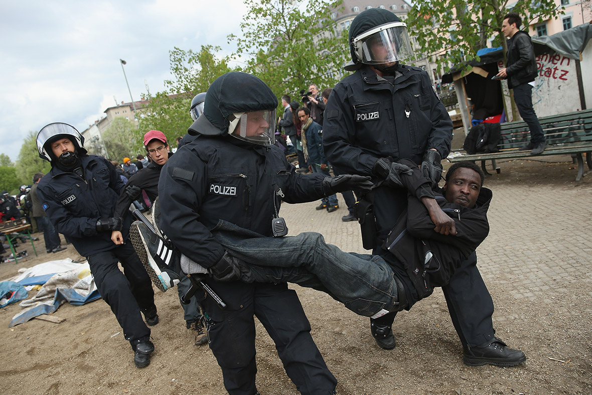 Riot police carry away a protester at a former temporary refugee camp at Oranienplatz in the Kreuzberg district of Berlin, Germany. Several hundred riot police sealed off the square after, according to an eyewitness, violence broke out between refugees who had accepted a deal by the city to leave the camp and a small number who insisted on staying