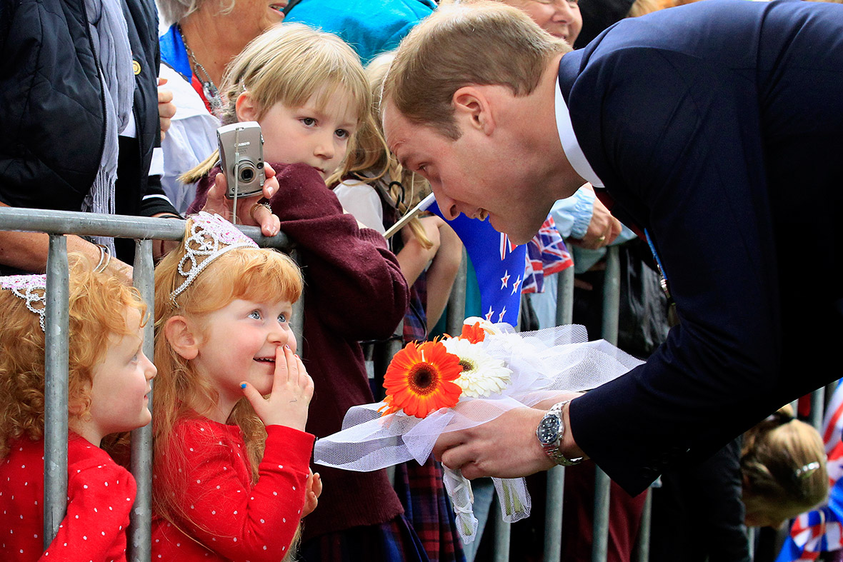 Prince William meets children in the crowd after laying a wreath with his wife at the war memorial in Seymour Square