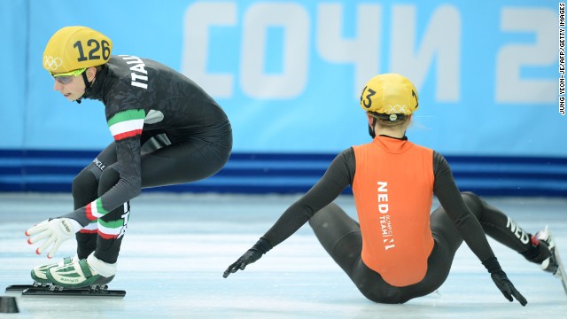 The Netherlands' Sanne van Kerkhof, right, falls next to Italy's Lucia Peretti as they compete in the 3,000-meter short track relay February 10.