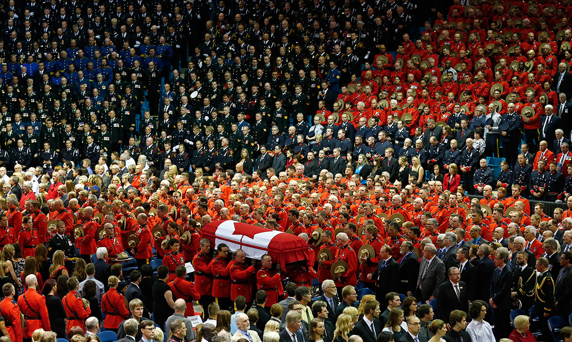 Pallbearers carry the coffin of one of three Royal Canadian Mounted Police officers killed last week in Moncton, New Brunswick, Canada