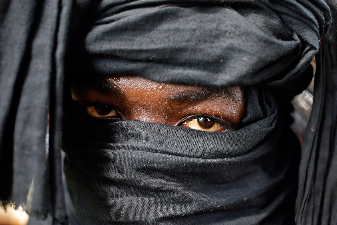 A Seleka fighter wearing a black scarf patrols the town of Kuango, close to the border between the Central African Republic and the Democratic Republic of Congo