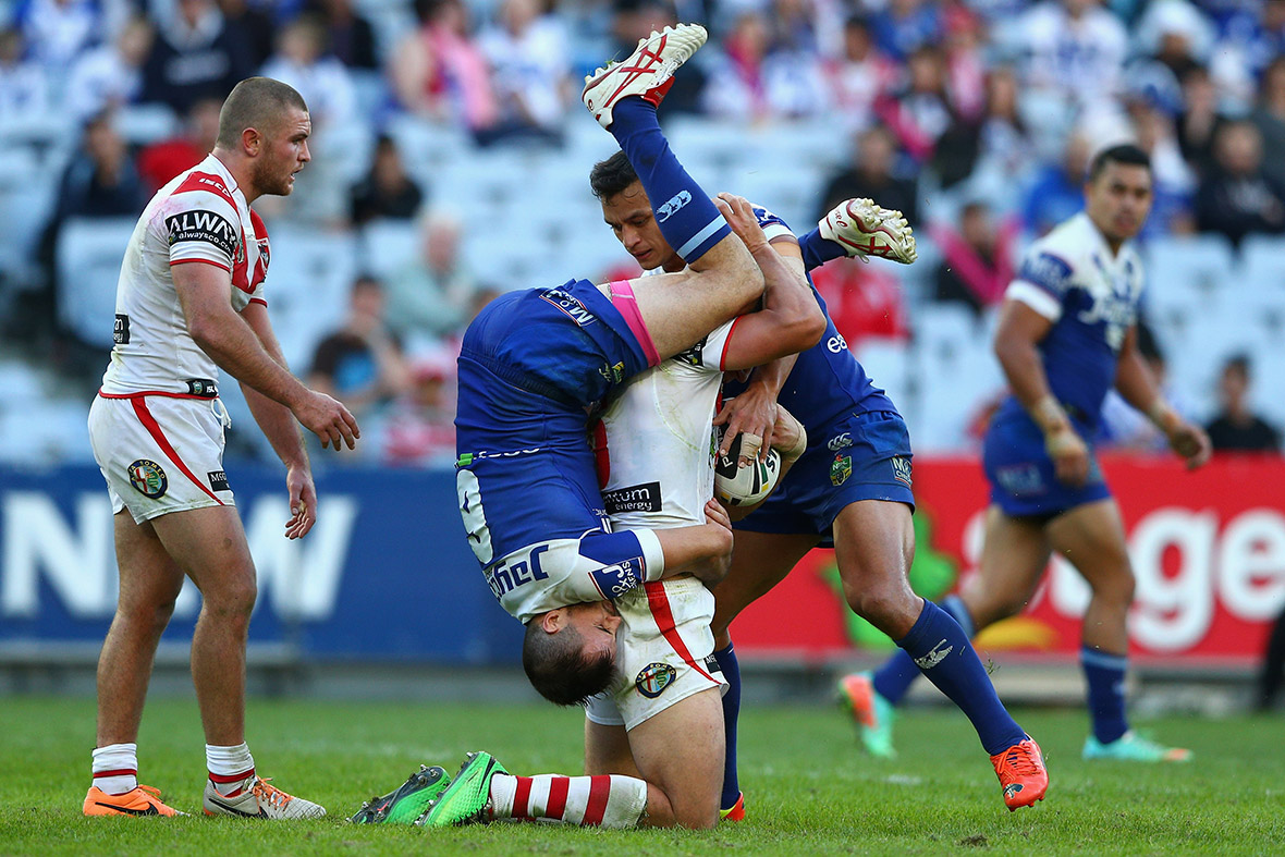 Gareth Widdop of the Dragons is tackled by Josh Reynolds and Sam Perrett of the Bulldogs during the round nine NRL match between the St George Illawarra Dragons and the Canterbury-Bankstown Bulldogs at ANZ Stadium in Sydney, Australia