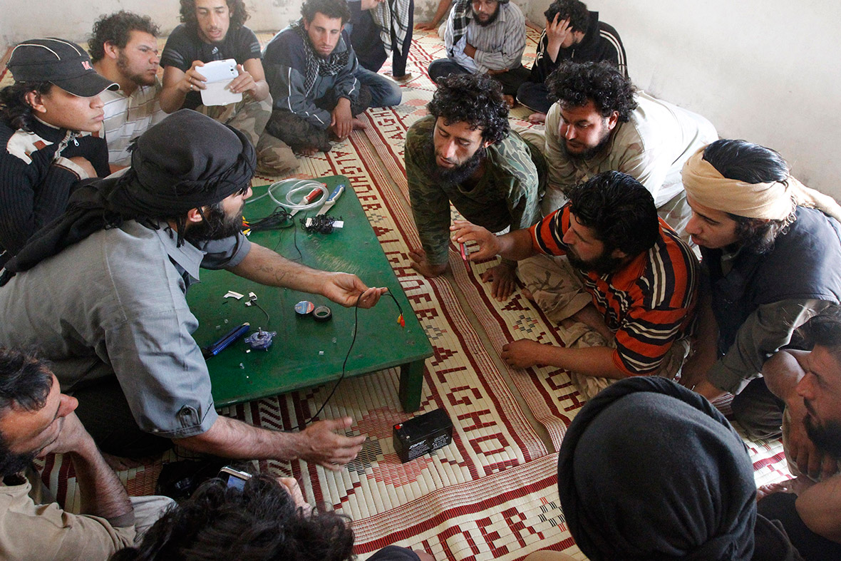 A rebel teaches fellow fighters how to make improvised explosive devices in Hama, Syria