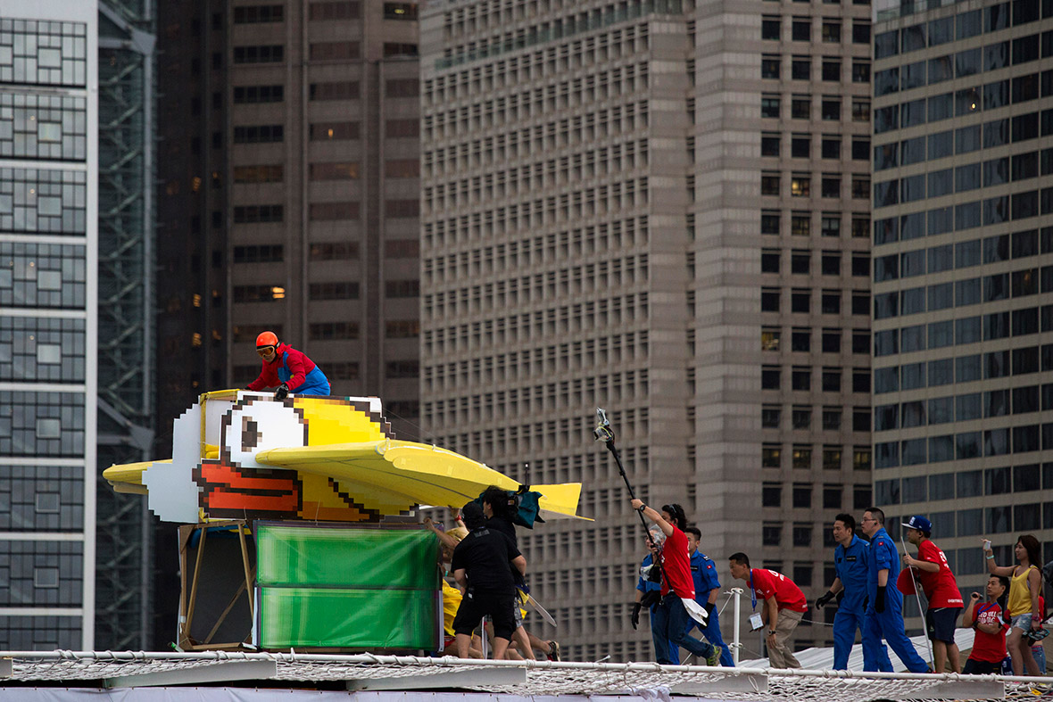 A participant operates a home-made Flappy Bird flying machine, during the Red Bull Flugtag event in Hong Kong. Participants from 43 teams competed to fly the longest distance in their aircraft