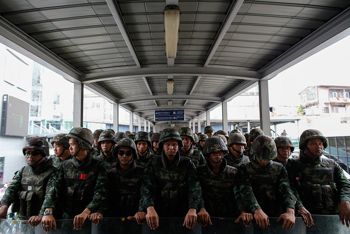 Soldiers block the entrance to an elevated train station near a shopping mall where anti-coup protesters were gathered in Bangkok