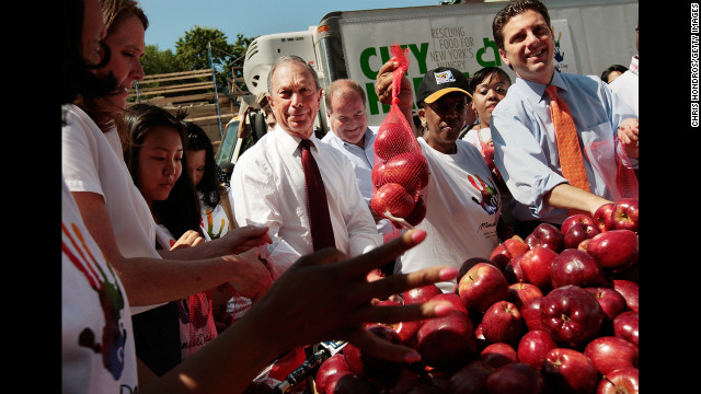 Bloomberg joins volunteers to bag apples for poor families as part of a Mandela Day event in July 2009. Mandela Day is a celebration of Nelson Mandela's life and legacy. It encourages good works and volunteerism around the world.