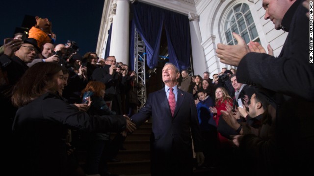 Bloomberg walks through the crowd outside City Hall as he leaves for the last time as mayor.
