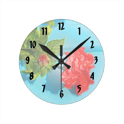 red rose against blue plastic wrap style round wall clocks