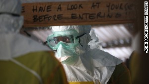A member of Doctors Without Borders prepares to enter a high-risk area of an Ebola treatment center in Liberia.