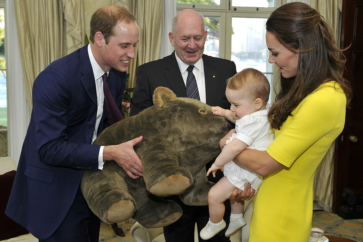 Prince George receives a gift of a giant stuffed wombat from Governor-General Sir Peter Cosgrove, while his parents Prince William and Kate Middleton look on, at Admiralty House in Sydney