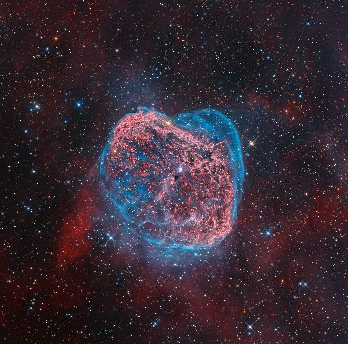 NGC 6888 by Mark Hanson (USA). This colourful starscape taken from Rancho Hidalgo, New Mexico, USA reveals the searing heat of the Crescent Nebula glowing in a whirl of red and blue. The emission nebula is a colossal shell of material ejected from a powerful but short-lived Wolf-Rayet star (WR 136), seen close to the image centre. Ultraviolet radiation and stellar wind now heats the swelling cloud, causing it to glow.