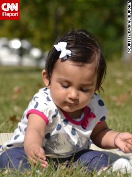 "Hey Mom ... I am picking some fresh greens for salad today" -- Rhea Purohit, age 9 months, forages in New Jersey's Liberty State Park.