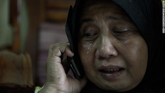 A relative of two passengers on the missing plane reacts at their home in Kuala Lumpur on March 8.