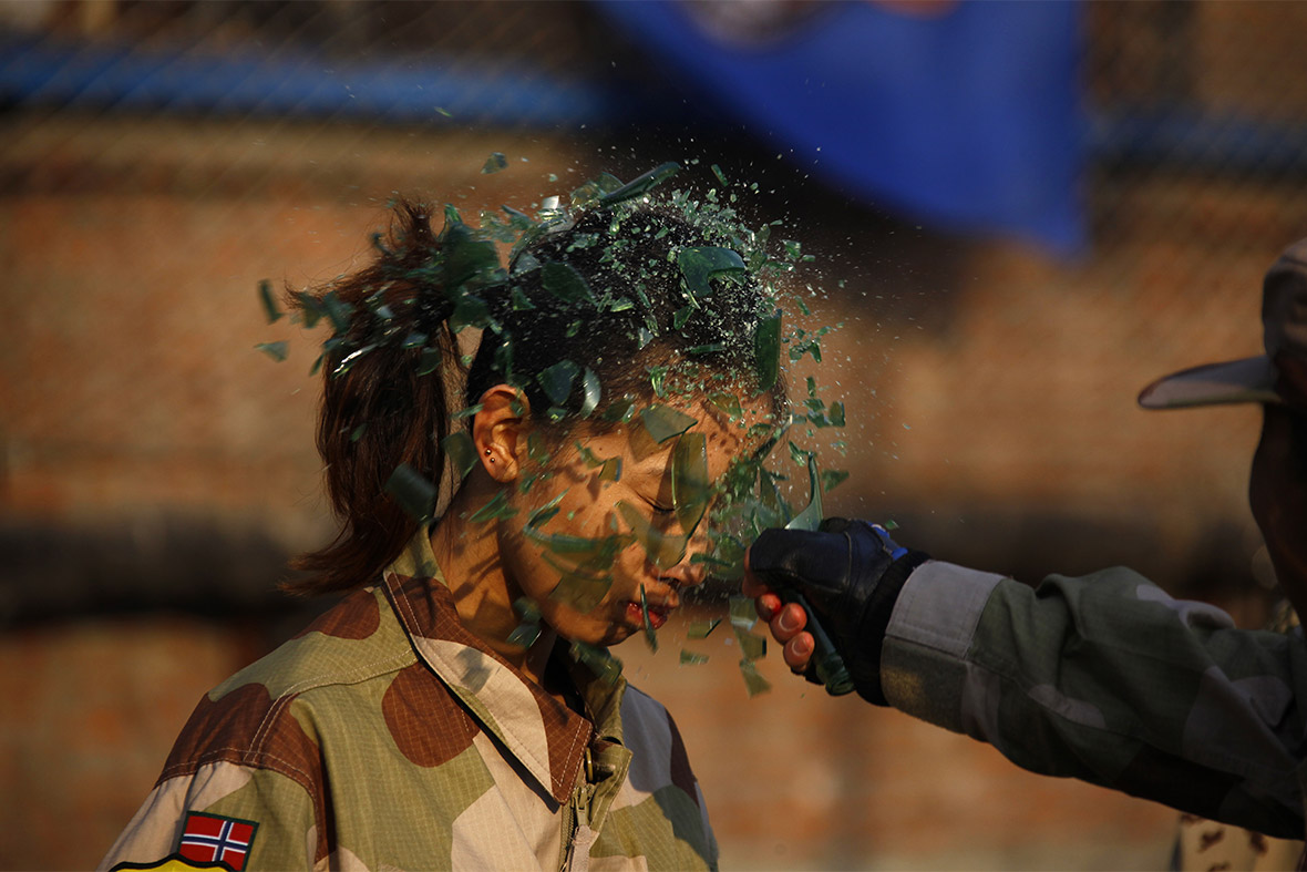 A recruit gets a bottle smashed over her head during a training session for China's first female bodyguards