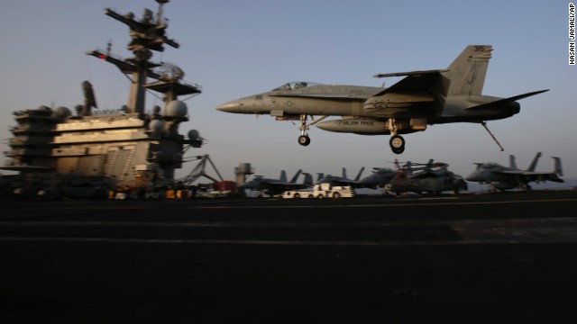 An F/A-18C Hornet lands on the flight deck of the USS George H.W. Bush on August 10.