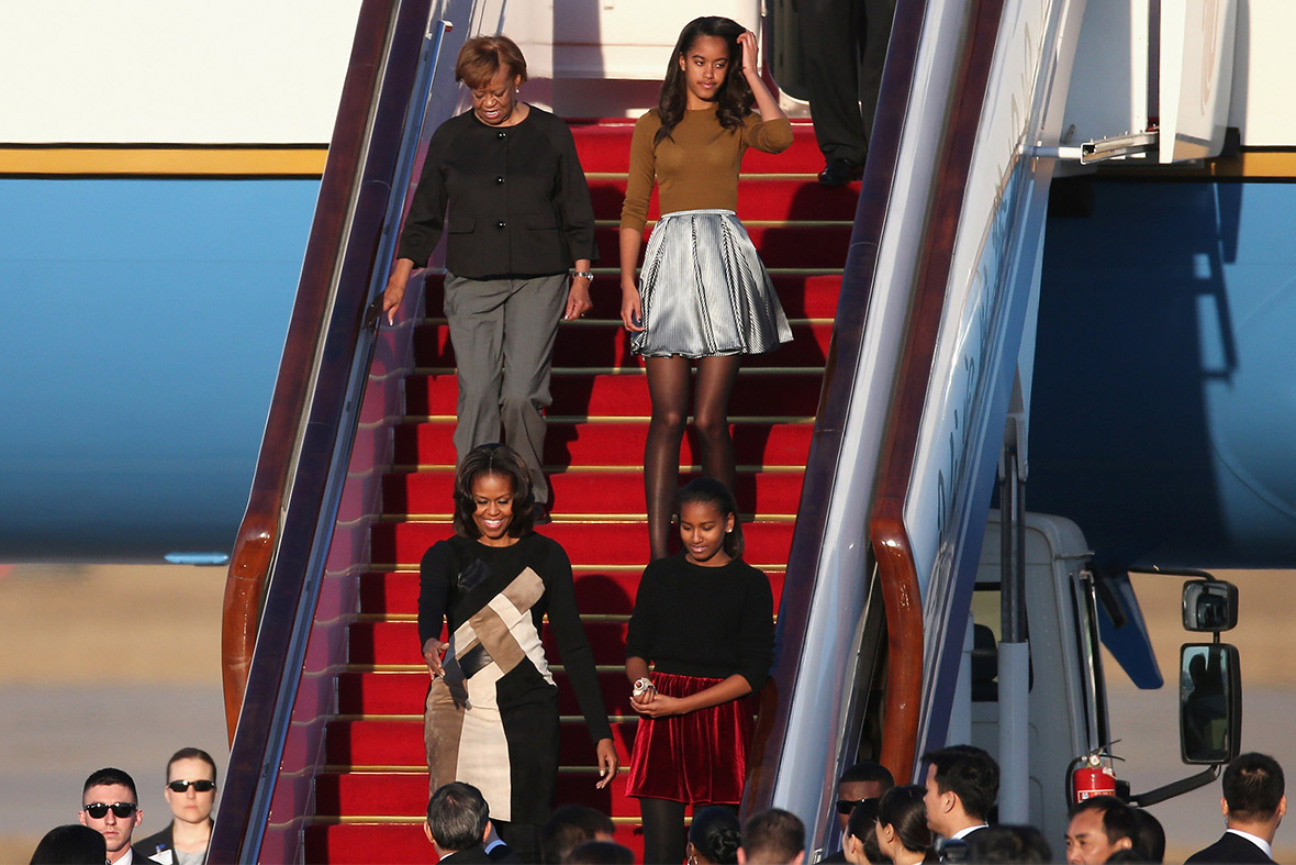 US First Lady Michelle Obama, her mother Marian Robinson, and daughters Sasha and Malia arrive at Beijing Capital International Airport for a six-day tour of China