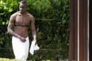 Italy forward Mario Balotelli wears a towel around his waist as he prepares for a sauna during a team training session at Coverciano training grounds, in Florence, Monday, May 26, 2014. In Brazil, Italy is in Group D with England, Uruguay and Costa Rica. (AP Photo/Fabrizio Giovannozzi)