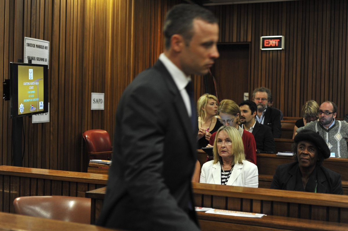 June Steenkamp (in white) watches Oscar Pistorius in court during his murder trial