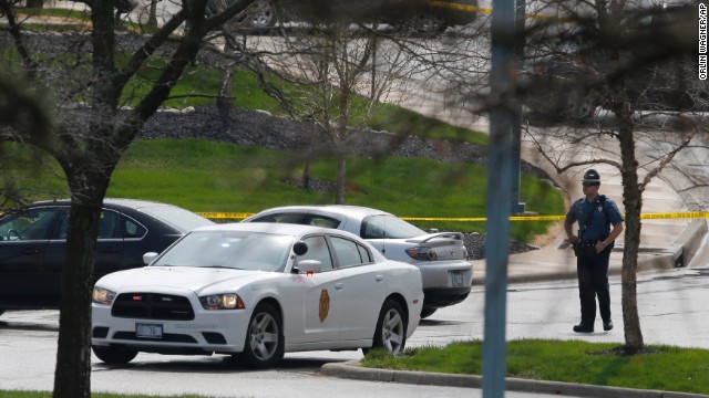 A Kansas State Trooper stands near the location of a shooting at the Jewish Community Center.