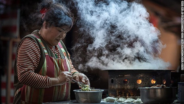 British photographer David Thompson took home top prize in the Food in the Street category for this image of a woman making jian bao dumplings.