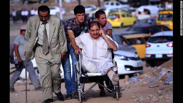 A man in a wheelchair is among those fleeing the violence on June 11.