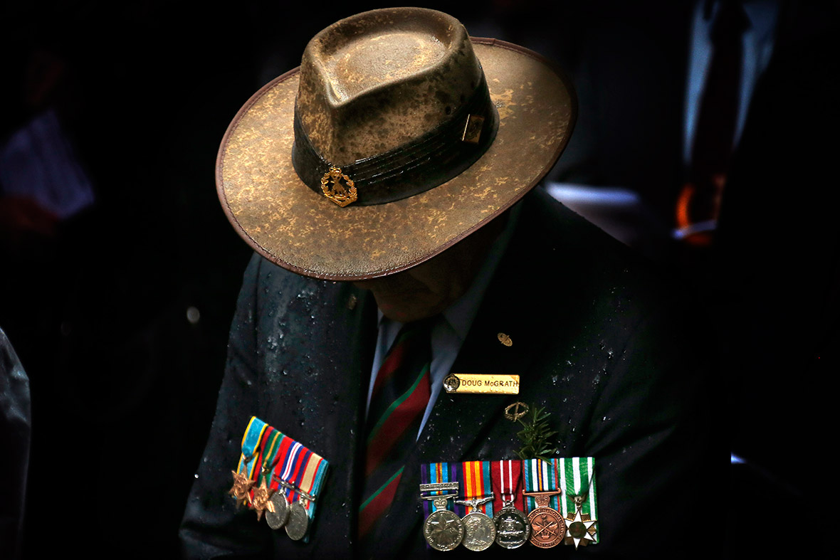 A veteran wearing service medals bows his head in the rain during a service to mark Anzac Day in Sydney. Australia and New Zealand marked the 99th anniversary of the first major military action involving their forces during the First World War