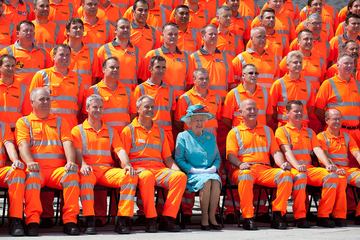 The Queen sits with construction workers as she opens the refurbished Reading Railway station.