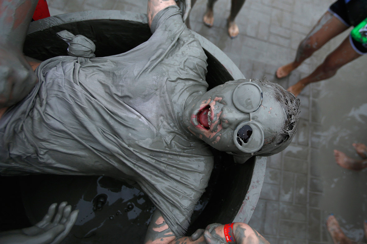 Tourists play in the mud during the Boryeong Mud Festival at Daecheon beach in South Korea.