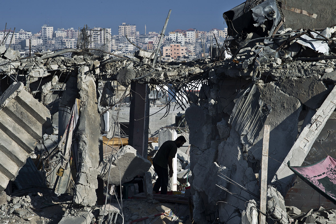 A man walks inside the shattered remains of his home in Gaza City's Shejaiya neighbourhood.