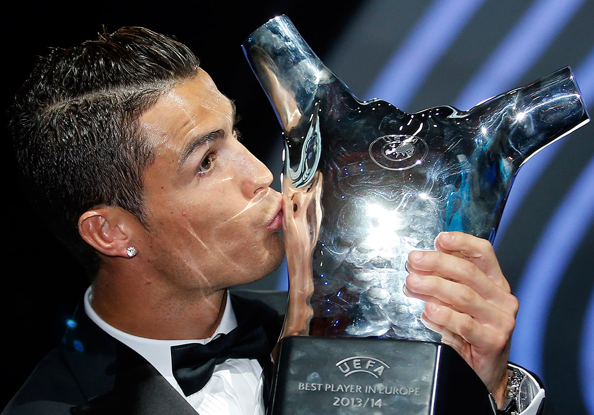 Real Madrid's Cristiano Ronaldo kisses his Best Player UEFA 2014 Award during the draw ceremony for the 2014/2015 Champions League in Monte Carlo