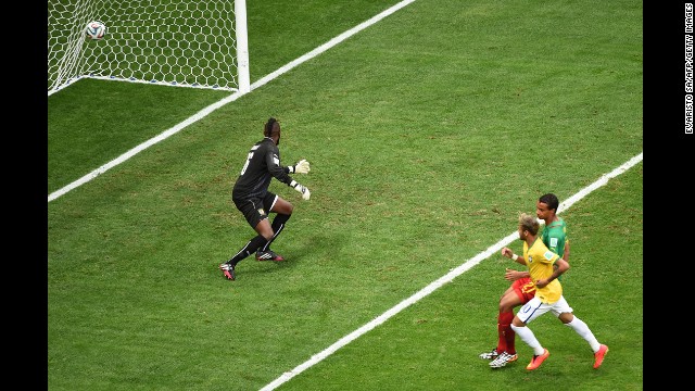 Brazil forward Neymar, right, scores Brazil's first goal past Cameroon goalkeeper Charles Itandje.
