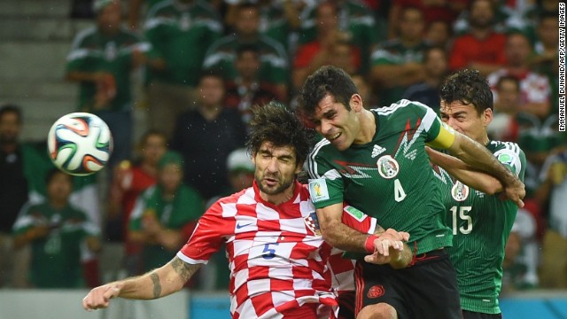 Mexico's Rafael Marquez, center, heads the ball to score his team's first goal against Croatia.