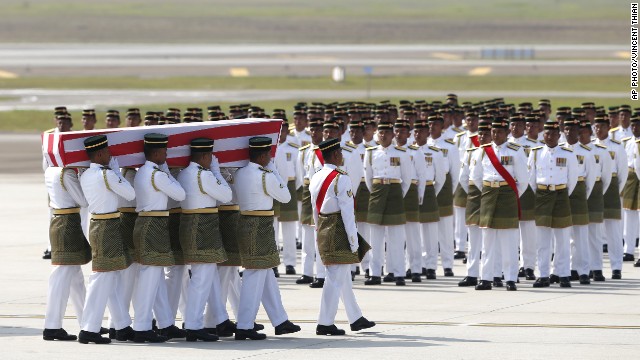 Malaysian Army soldiers carry a coffin containing the remains of one of the passengers aboard Flight MH17, which was shot down over eastern Ukraine last month.