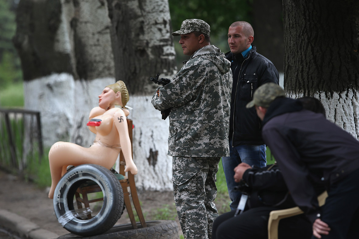 An inflatable doll with a swastika on her arm and a Yulia Tymoshenko hairdo adorns a pro-Russian militia checkpoint in Slovyansk, Ukraine.