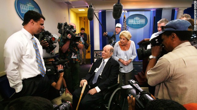 Brady visits the White House Briefing Room with his wife, Sarah, as White House Deputy Press Secretary Bill Burton, left, shows them around in June 2009.