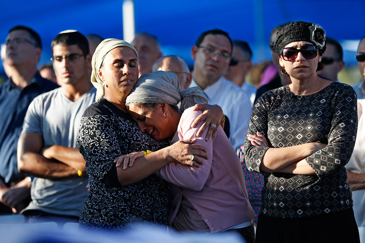 Bat-Galim Shaer (R) and Iris Yifrah (C), mothers of two of the three Israeli teens who were abducted and killed in the occupied West Bank, mourn during the joint funeral of their sons in the Israeli city of Modi'in