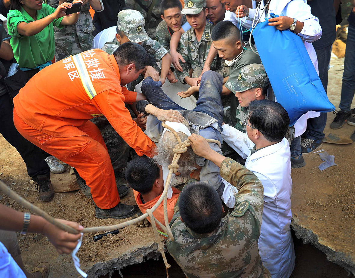 Xiong Zhengfen, 88, is rescued after being buried underneath earthquake debris for more than 50 hours in the Village of Babao, southern Yunnan province, China