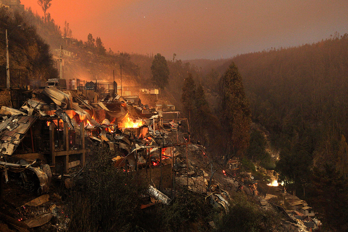 Properties in the hills above Valparaiso are reduced to glowing embers